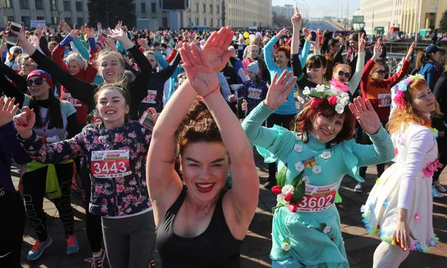 Participants of the “Beauty run” warm up before dashing down the main Nezavisimosti avenue in Minsk, Belarus, 08 March 2019. About 5,000 participants took part in the event in connection with International Women's Day. International Women's Day (IWD) is a global day that celebrates women's achievements in socially, economically, culturally and politically and also an invitation for all elements of society to accelerate gender equality. (Photo by Tatyana Zenkovich/EPA/EFE)