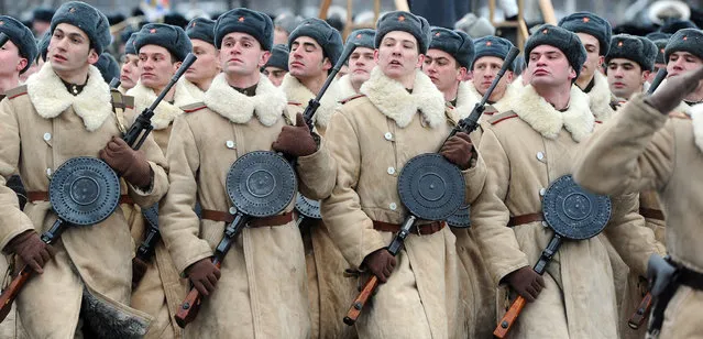 Wearing WWII-era winter clothing of Red Army Russian soldiers march during a military parade to mark the 70th anniversary of the final raise of the Nazi blockade of the city Leningrad, now St. Petersburg, on January 27, 2014. The German and Finnish siege and blockade of Leningrad was broken on January 18, 1943 but finally lifted a year after, on January 27, 1944. (Photo by Olga Maltseva/AFP Photo)
