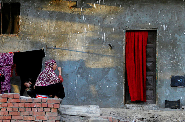 A woman looks on next to her daughter at a slum area near downtown Cairo, Egypt, November 23, 2016. (Photo by Amr Abdallah Dalsh/Reuters)