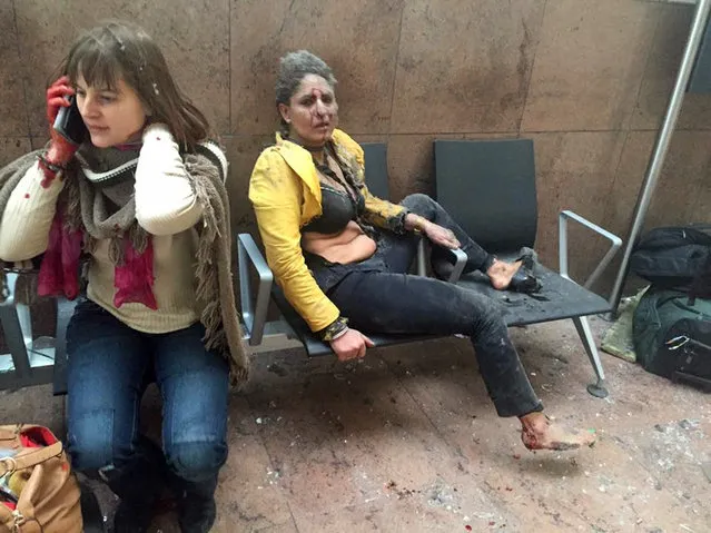 In this photo provided by Georgian Public Broadcaster and photographed by Ketevan Kardava two women wounded in Brussels Airport in Brussels, Belgium, after explosions were heard Tuesday, March 22, 2016. A developing situation left at least one person and possibly more dead in explosions that ripped through the departure hall at Brussels airport Tuesday, police said. All flights were canceled, arriving planes were being diverted and Belgium's terror alert level was raised to maximum, officials said. (Photo by Ketevan Kardava/Georgian Public Broadcaster via AP Photo)