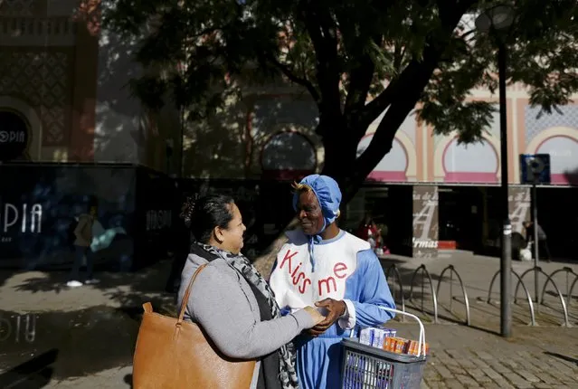 Howard Jackson, a Liberian migrant, chats with a friend in the Andalusian capital of Seville, southern Spain February 25, 2016. (Photo by Marcelo del Pozo/Reuters)