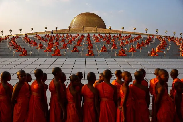 Buddhist monks pray at the Wat Phra Dhammakaya temple during a ceremony commemorating Makha Bucha Day in Pathum Thani province outside Bangkok, Thailand, on February 24, 2024. (Photo by Athit Perawongmetha/Reuters)