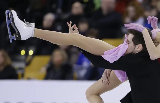 Maxim Nikitin, of Ukraine, gets a face full of a skirt from his partner Alexandra Nazarova as they compete during the Ice Dance short program at the World Figure Skating Championships, Wednesday, March 30, 2016, in Boston. (Photo by Elise Amendola/AP Photo)