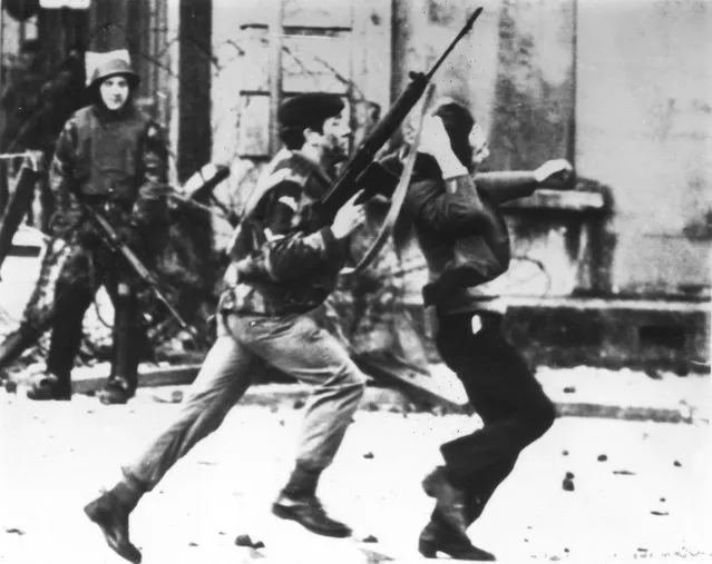 An armed soldier attacks a protestor on Bloody Sunday when British Paratroopers shot dead 13 civilians on a civil rights march in Derry City, on 30th January 1972. (Photo by Frederick Hoare/Central Press/Getty Images)