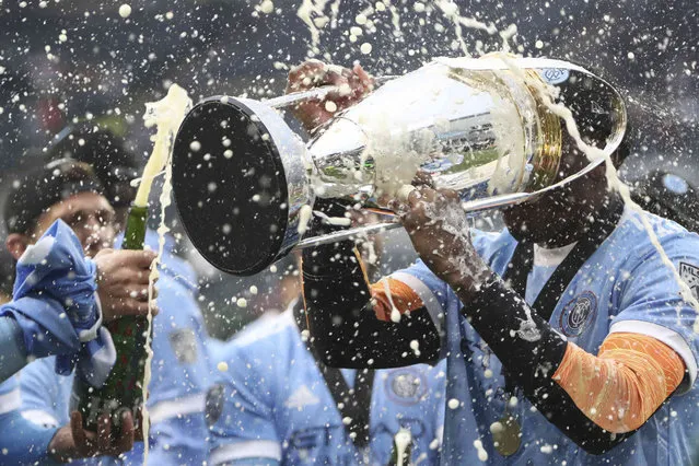New York City FC goalkeeper Sean Johnson (1) drinks from the trophy after their penalty kick shootout win over the Portland Timbers in the MLS Cup soccer game, Saturday, December 11, 2021, in Portland, Ore. (Photo by Amanda Loman/AP Photo)