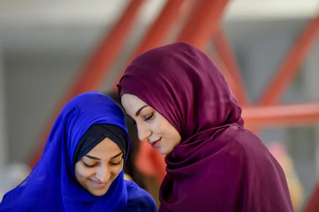 Girls wait for the start of Eid al-Fitr prayers in Bucharest, Romania, Tuesday, June 4, 2019. Members of the Romanian Muslim community gathered for Eid al-Fitr prayers, marking the end of the holy fasting month of Ramadan. (Photo by Andreea Alexandru/AP Photo)