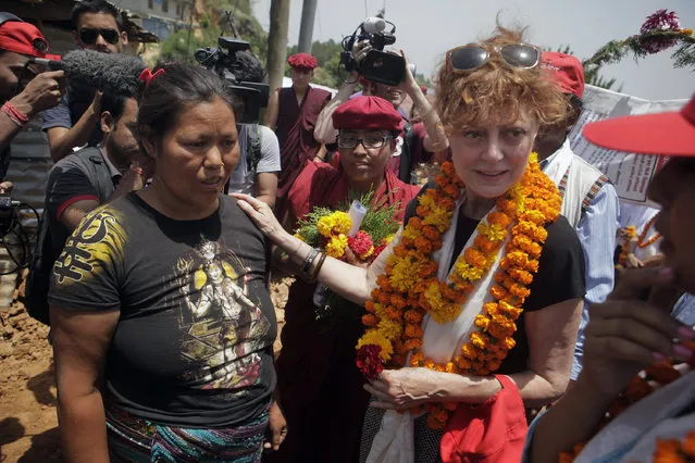 Oscar-winning Hollywood actress Susan Sarandon, right, comforts Kanti Maya Tamang, who lost her husband and daughter in the April 25 earthquake, at Ramkot village on the outskirts of Kathmandu, Nepal, Sunday, May 24, 2015. Sarandon is in Nepal for five days, urging tourists to come to the Himalayan nation where two powerful earthquakes have killed thousands of people and made several hundreds of thousands homeless. (Photo by Niranjan Shrestha/AP Photo)