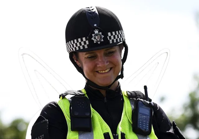 A horse mounted police officer, wearing fairy wings, smiles during the Glastonbury Festival at Worthy Farm in Somerset, Britain, June 25, 2015. (Photo by Dylan Martinez/Reuters)
