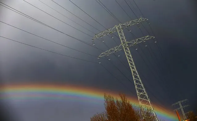 A rainbow is seen behind a power line in Berlin, Germany, March 29, 2016. (Photo by Hannibal Hanschke/Reuters)