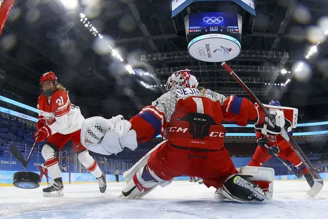 Denmark's Michelle Weis (21) scores a goal against Czech Republic goalkeeper Viktorie Svejdova (1) during a preliminary round women’s hockey game at the 2022 Winter Olympics, Monday, February 7, 2022, in Beijing. (Photo by David W. Cerny/Pool Photo via AP Photo)