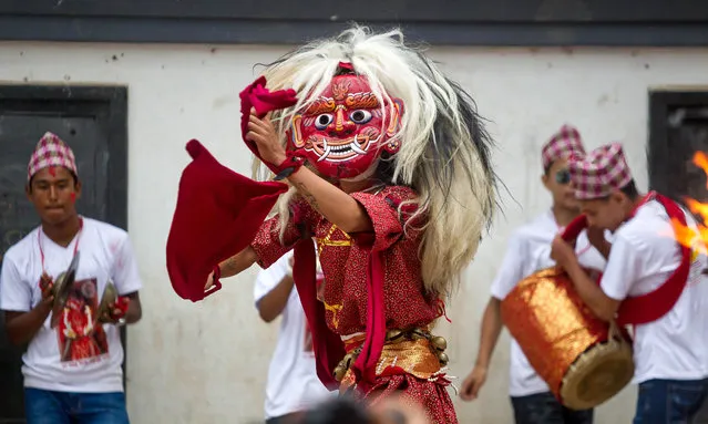 A masked dancer performs traditional dance during a Newari festival in Lalitpur, Nepal on August 1, 2019. (Photo by Xinhua News Agency/Rex Features/Shutterstock)