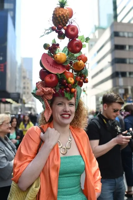 A participant displays her outfit during the annual Easter Parade on Fifth Avenue in New York on April 20, 2014. The annual parade has been a New York tradition since the late 1880s, during which participants gather, donning all mode of spring finery and hat, from wacky to traditional. (Photo by Emmanuel Dunand/AFP Photo)