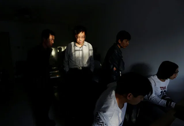 Wu Yaxiong (2nd L), CEO of N-Wei (Beijing) Technology Company Limited, stands with his programmers in an apartment which he rents as office and employees' dormitory, in Beijing, China, April 22, 2016. (Photo by Jason Lee/Reuters)