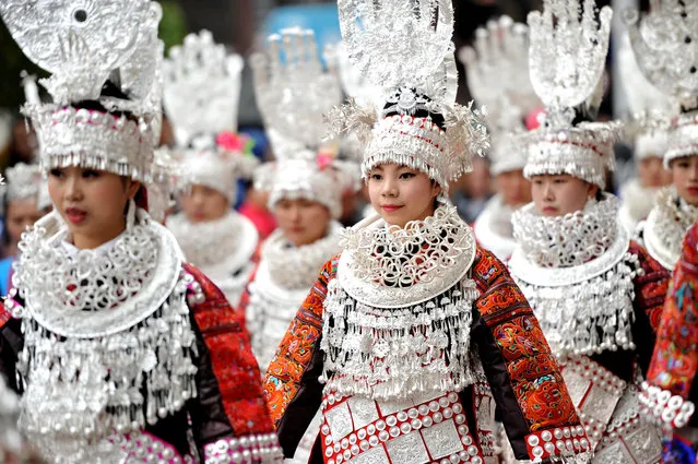 Ethnic Miao women wearing traditional costumes parade during a local festival in Taijiang county, Guizhou province, China April 10, 2017. (Photo by Reuters/China Daily)