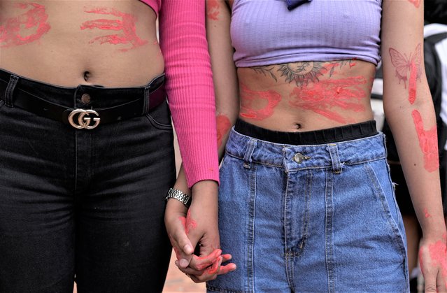 Women with red paint on their bodies participate in a rally to mark International Women's Day, in Bogota, Colombia on March 8, 2023. (Photo by Mahe Elipe/Reuters)