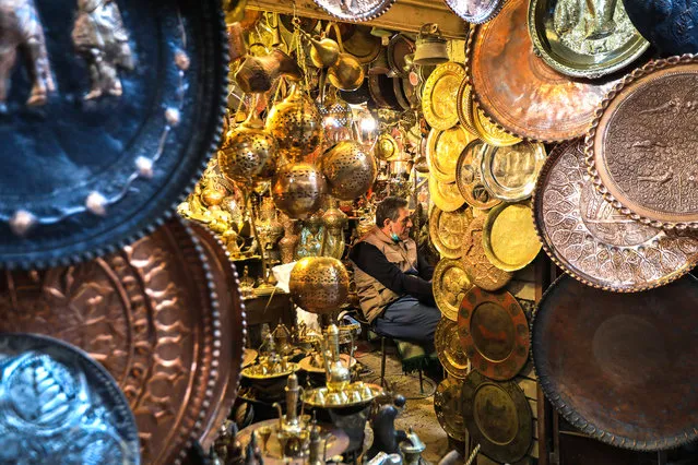 A seller and copper products are seen at Coppersmith Bazaar in Baghdad, Iraq on March 15, 2022. (Photo by Murtadha Al-Sudani/Anadolu Agency via Getty Images)