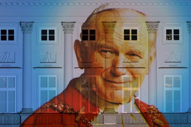 A picture of Pope John Paul II is displayed on the facade of the Presidential Palace in Warsaw, Poland on March 9, 2023. (Photo by Kuba Stezycki/Reuters)