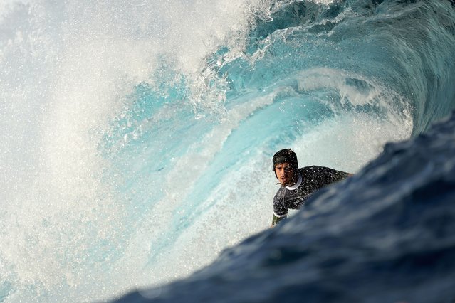 Joao Chianca, of Brazil, surfs on a training day ahead of the 2024 Summer Olympics surfing competition, Tuesday, July 23, 2024, in Teahupo'o, Tahiti. (Photo by Gregory Bull/AP Photo)