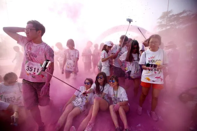 Participants enjoy the “Color Me Run” festival in Hanoi, Vietnam, 28 May 2016. The festival which was inspired by the Holi Festival from India, attracted thousands of teenagers this year. (Photo by Luong Thai Linh/EPA)