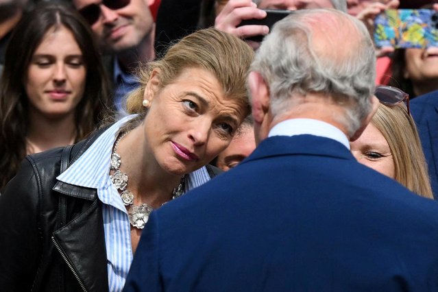 A member of the public reacts as she meets with Britain's King Charles III (R) in Covent Garden, central London, on May 17, 2023, during a visit with Britain's Queen Camilla, their first joint engagement since the coronation. (Photo by Daniel Leal/Pool via AFP Photo)