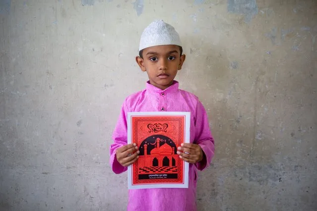 A Bangladeshi Muslim boy holds the Holy Koran at the Madrasa during the Holy month of Ramadan in Dhaka, Bangladesh, 18 April 2022. Muslims around the world celebrate Ramadan by abstaining from eating, drinking, and sexual acts daily between sunrise and sunset and performing an extra prayer at night. (Photo by Monirul Alam/EPA/EFE)