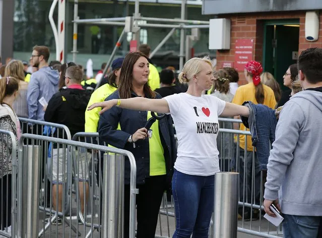 Concert-goers are checked by security on arrival at US singer Ariana Grande's One Love Manchester concert at Old Trafford Cricket Ground in Manchester, Britain, 04 June 2017. Grande returns to Manchester for an all-star concert as tribute to the victims of a suicide bombing attack during her previous concert at the Manchester Arena on late 22 May, that resulted in the deaths of at least 22 people and the serious injuries of dozens of others. (Photo by Nigel Roddis/EPA)