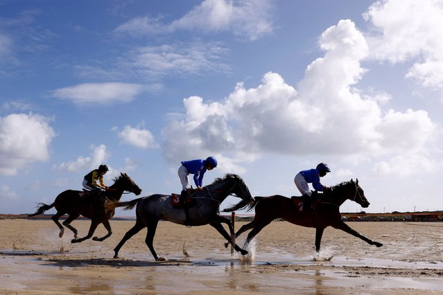 Jockeys compete in beach horse racing on Omey Island, in Claddaghduff, Ireland on August 24, 2024. (Photo by Clodagh Kilcoyne/Reuters)