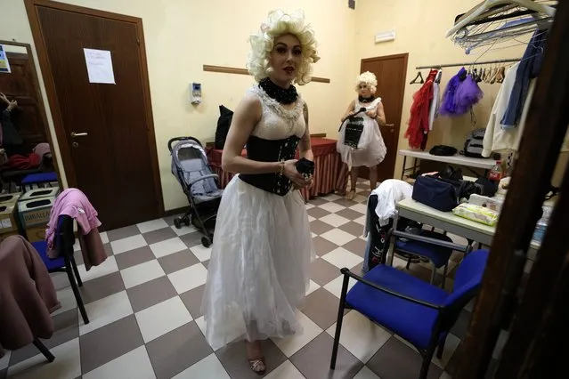 Performer Hanna Honcharenko, walks backstage before the start of the show “Alice in Wonderland” in Pistoia, Italy, Friday, May 6, 2022. A Ukrainian circus troupe is performing a never-ending “Alice in Wonderland” tour of Italy. They are caught in the real-world rabbit hole of having to create joyful performances on stage while their families at home are living through war. The tour of the Theatre Circus Elysium of Kyiv was originally scheduled to end in mid-March. (Photo by Alessandra Tarantino/AP Photo)