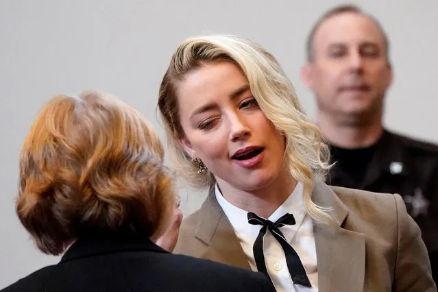US actress Amber Heard talks to her attorney Elaine Bredehoft in the courtroom before leaving for the day, at the Fairfax County Circuit Courthouse in Fairfax, Virginia, on May 23, 2022. US actor Johnny Depp sued his ex-wife Amber Heard for libel in Fairfax County Circuit Court after she wrote an op-ed piece in The Washington Post in 2018 referring to herself as a “public figure representing domestic abuse”. (Photo by Steve Helber/Pool via AFP Photo)