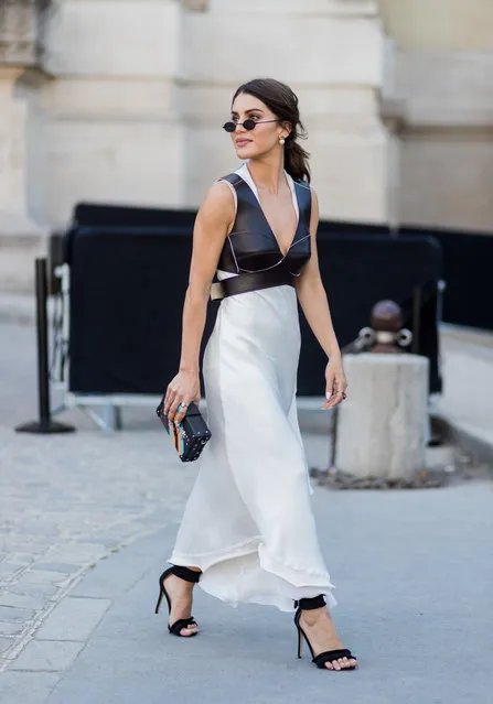 Camila Coelho wearing a white dress, black vest outside Ralph & Russo during Paris Fashion Week – Haute Couture Fall/Winter 2017-2018 : Day Two on July 3, 2017 in Paris, France. (Photo by Christian Vierig/Getty Images)