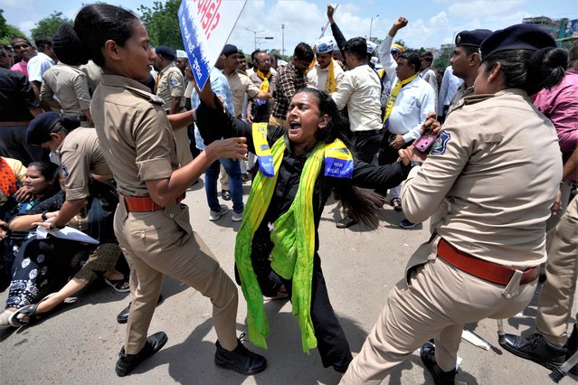 Police detains a supporter of Aam Aadmi Part (AAP) as they try rally in protest against the growing oppression of women in northeastern Manipur state and across the country, in Ahmedabad, India, Tuesday, July 25, 2023. Protests have erupted across the country after a video showing mob assaults on two women who were paraded naked sparked widespread outrage on social media. More than 130 people have been killed in the northeastern state since violence between two dominant ethnic groups erupted in early May. (Photo by Ajit Solanki/AP Photo)