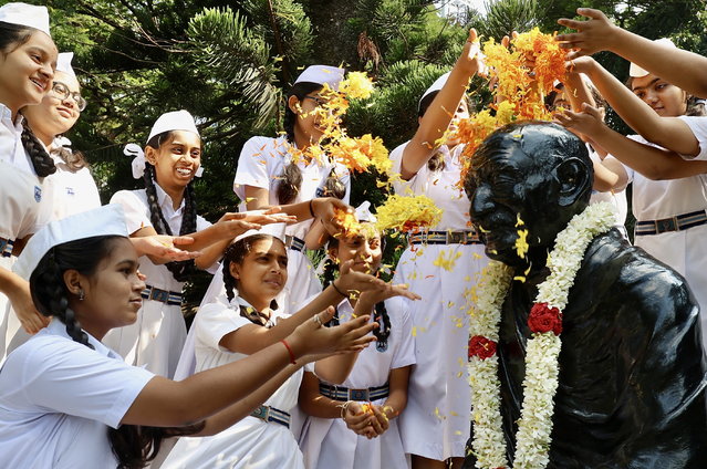 Indian school children throw flowers over a statue of Mahatma Gandhi as they pay their respects during the Gandhi Jayanthi celebration that marks Gandhi's birth anniversary in Bangalore, India, 02 October 2024. Gandhi Jayanti is celebrated annually across India on 02 October, to mark the birthday of Mohandas Karamchand Gandhi. This year marks the 155th birth anniversary of Mahatma Gandhi, also known as the father of the Indian nation. (Photo by Jagadeesh N.V./EPA)