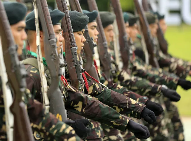 Filipino army soldiers parade during Defense Secretary Voltaire Gazmin's (unseen) visit to a military camp in Taguig city, south of Manila, Philippines, 24 June 2016. According to defense secretary Voltaire Gazmin, the armed forces of the Philippines continue pursuing the Abu Sayyaf in southern Philippines as the terrorist group abducted anew seven Indonesian sailors. The Islamist Abu Sayyaf group released Filipino hostage Marites Flor, western Mindanao command spokesman Filemon Tan said. (Photo by Eugenio Loreto/EPA)
