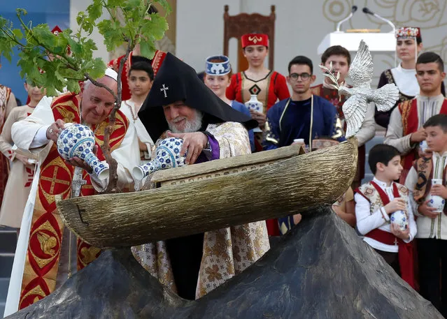 Pope Francis (L) and Catholicos of All Armenians Karekin II water a tree planted in an Noah's Ark model during an ecumenical service at the Republic Square in Yerevan, Armenia, June 25, 2016. (Photo by Alessandro Bianchi/Reuters)