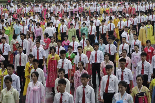 North Korean university students wait for the start of a mass dance on Thursday, July 27, 2017, in Pyongyang, North Korea as part of celebrations for the 64th anniversary of the armistice that ended the Korean War. (Photo by Wong Maye-E/AP Photo)