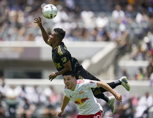 Los Angeles FC forward Latif Blessing (7) jumps over New York Red Bulls midfielder Lewis Morgan (10) to head the ball during the first half of an MLS soccer match in Los Angeles, Sunday, June 26, 2022. (Photo by Ashley Landis/AP Photo)