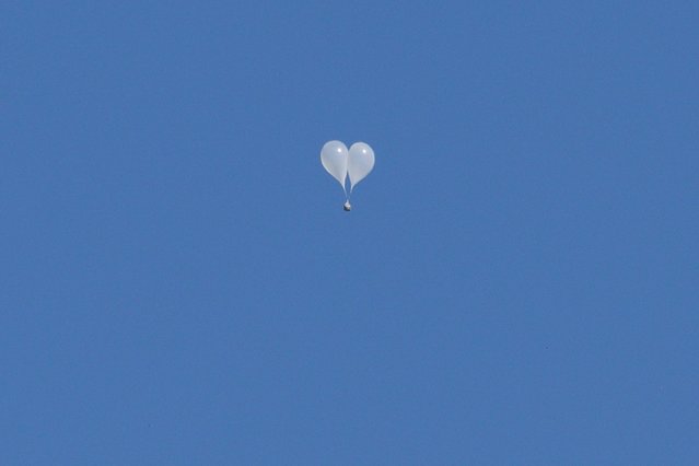 Trash-carrying balloons launched across the border by North Korea are seen floating in the sky above Seoul on October 4, 2024. Relations between the two Koreas are at one of their lowest points in years, with Pyongyang ramping up weapons tests and bombarding the South with balloons carrying rubbish, and Seoul suspending a military deal and resuming propaganda broadcasts in response. (Photo by Anthony Wallace/AFP Photo)