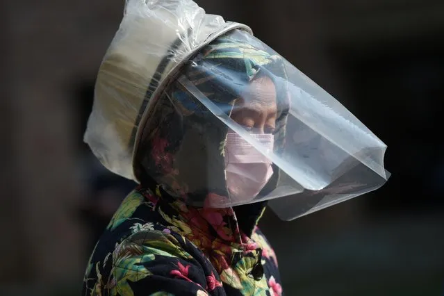 A resident wears a makeshift protective face shield at a residential compound in Wuhan, the epicenter of the novel coronavirus outbreak, Hubei province, China on February 21, 2020. (Photo by Reuters/China Stringer Network)