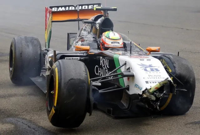 Force India's Mexican driver Sergio Perez sits in his wrecked car during the Hungarian Formula One Grand Prix at the Hungaroring circuit in Budapest on July 27, 2014. Red Bull Racing's Australian driver Daniel Ricciardo won the race ahead of Scuderia Ferrari's Spanish driver Fernando Alonso (2nd) and Mercedes' British driver Lewis Hamilton (3rd). (Photo by Darko Bandic/AFP Photo)