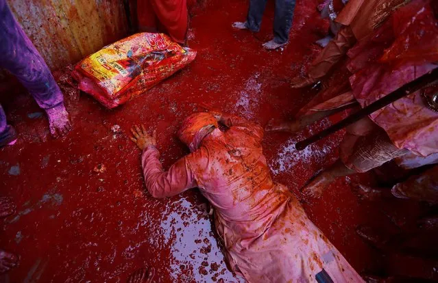 A Hindu devotee prays as he takes part in the religious festival of Holi inside a temple in Nandgaon village, in the state of Uttar Pradesh, India March 5, 2020. (Photo by Adnan Abidi/Reuters)