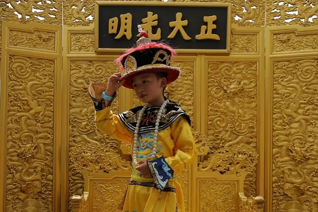 A picture made available on 11 July 2016 shows a Chinese boy dressed in an imperial costume as he takes souvenir pictures at the Jingshan Park in Beijing, China, 06 July 2016. China has a current population of 1.38 billion as of 06 July 2016 according to the latest United Nations estimates. This is equivalent to 18.72 percent of the total world population, making it the most populous country in the world. The most populous country of the world has a peculiar demographic situation as a result of more than three decades of the 'one child policy'. (Photo by Wu Hong/EPA)