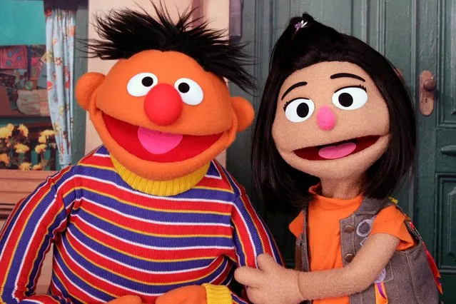 Ernie, a muppet from the popular children's series “Sesame Street”, appears with new character Ji-Young, the first Asian American muppet, on the set of the long-running children's program in New York on November 1, 2021. Ji-Young is Korean American and has two passions: rocking out on her electric guitar and skateboarding. (Photo by Noreen Nasir/AP Photo)