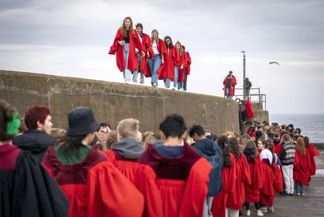 Undergraduates at the University of St Andrews, United Kingdom take part in the traditional Pier Walk along the harbour walls of St Andrews on Sunday, September 4, 2022 before the start of the new academic year. (Photo by Jane Barlow/PA Images via Getty Images)