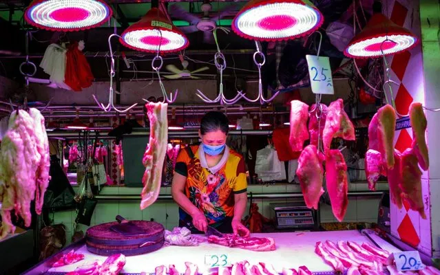 A vendor wearing a mask sells meat on Xihua Farmer's Market in Guangzhou, Guangdong province, China, 04 May 2020. (Photo by Alex Plavevski/EPA/EFE/Rex Features/Shutterstock)