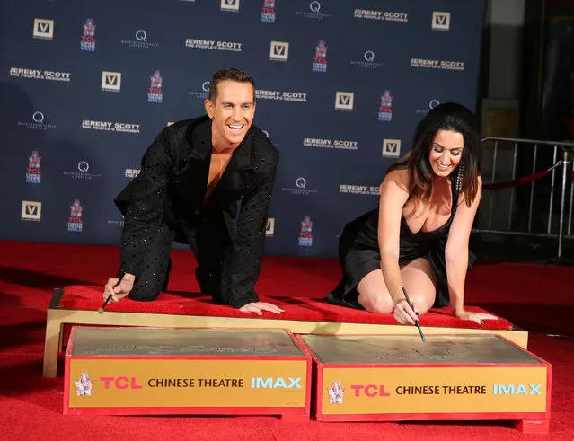 Jeremy Scott, left, and Katy Perry participate in the hand print ceremony at the World Premiere of JEREMY SCOTT: THE PEOPLE'S DESIGNER, presented by The Vladar Company and Quintessentially at the TCL Chinese Theatre on Tuesday, September 8, 2015, in Hollywood, Calif. (Photo by Matt Sayles/Invision for The Vladar Company/AP Images)