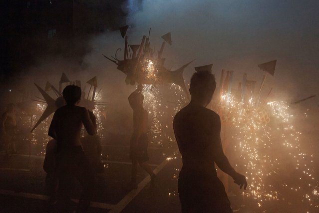 Performers set off fireworks during a parade celebrating the Lantern Festival in Meizhou, China, on Wednesday, February 12, 2025. (Photo by AFP Photo/China Stringer Network)