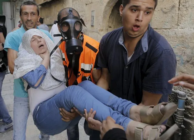 A Palestinian woman affected by tear gas is evacuated by medics during clashes between stone-throwing Palestinians and Israeli police on the compound known to Muslims as Noble Sanctuary and to Jews as Temple Mount in Jerusalem's Old City September 15, 2015. The U.S. State Department on Monday voiced concern about violence at the compound surrounding Jerusalem's Al-Aqsa mosque, an area revered by Muslims as the Noble Sanctuary and by Jews as the Temple Mount. (Photo by Ammar Awad/Reuters)