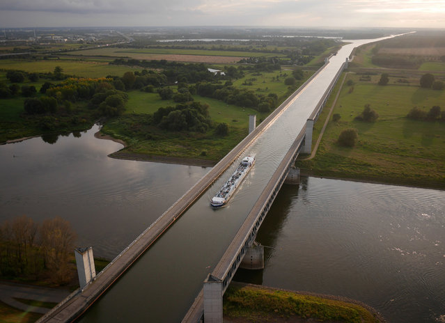 A barge chugs along the Magdeburg Water Bridge, Germany. (Photo by Amos Chapple/Rex Features)