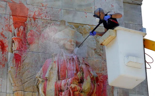 A member of the New York City Monuments and Conservation department power washes the statue of former US President George Washington after the statue got covered in red paint after being vandalised in Washington Square Park in New York, New York, 29 June 2020. (Photo by Jason Szenes/EPA/EFE)