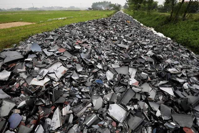 Broken TV and computer screens are seen at a garbage dump near a rice field in Vinh Phuc province, Vietnam, June 5, 2020. (Photo by Kham via Reuters)